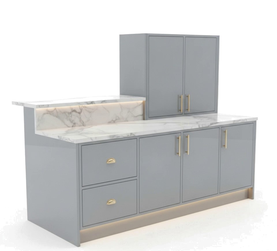 A grey modular kitchen cabinet with marble countertop and brass handles.