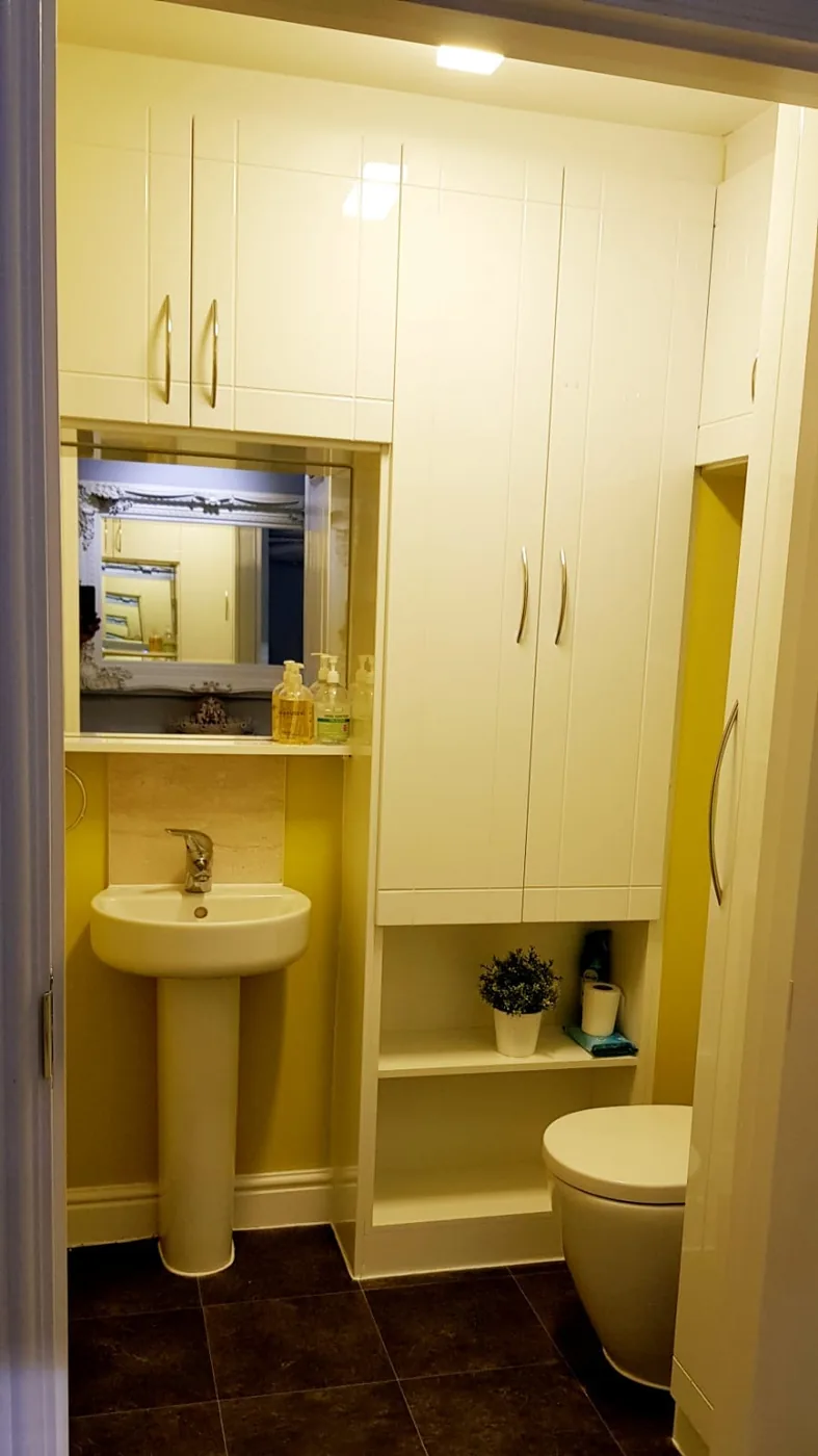 Cream fitted bathroom cabinet · pedestal basin & concealed cistern