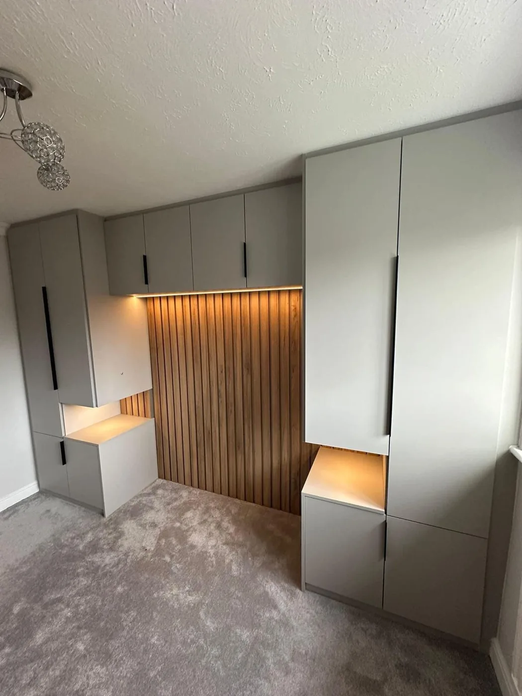 Grey fitted wardrobes · slatted oak headboard nook · LED