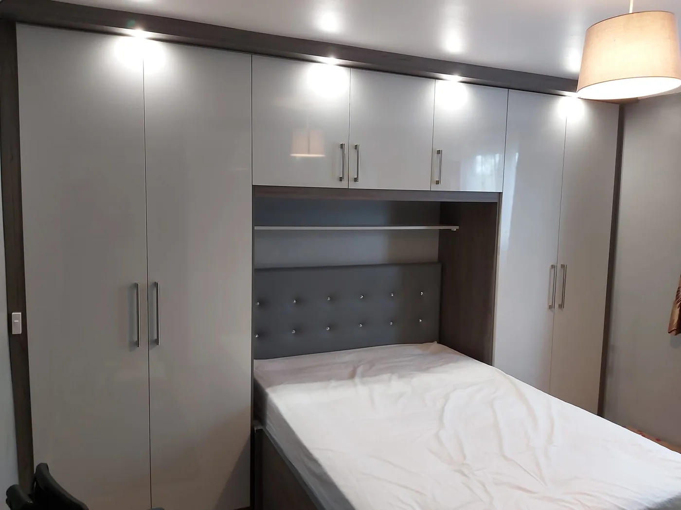 Pearl white overbed wardrobes · crystal-button headboard nook