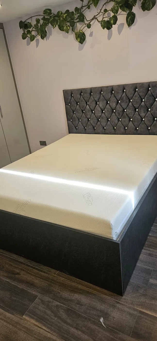 Charcoal diamond-button headboard · crystal detail