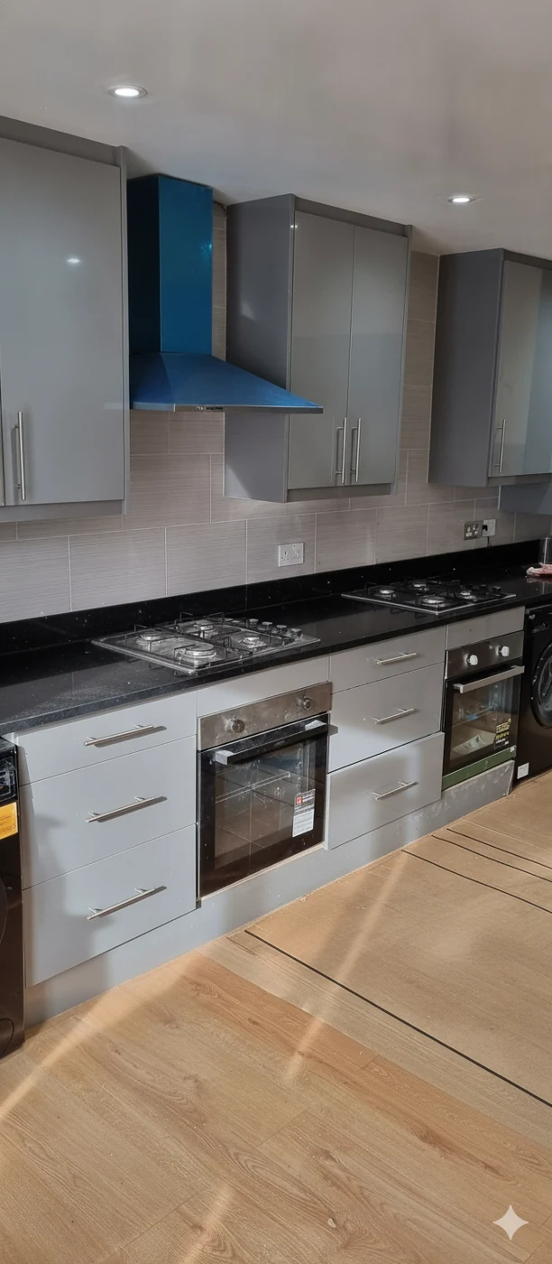 Grey gloss kitchen · black granite & blue hood