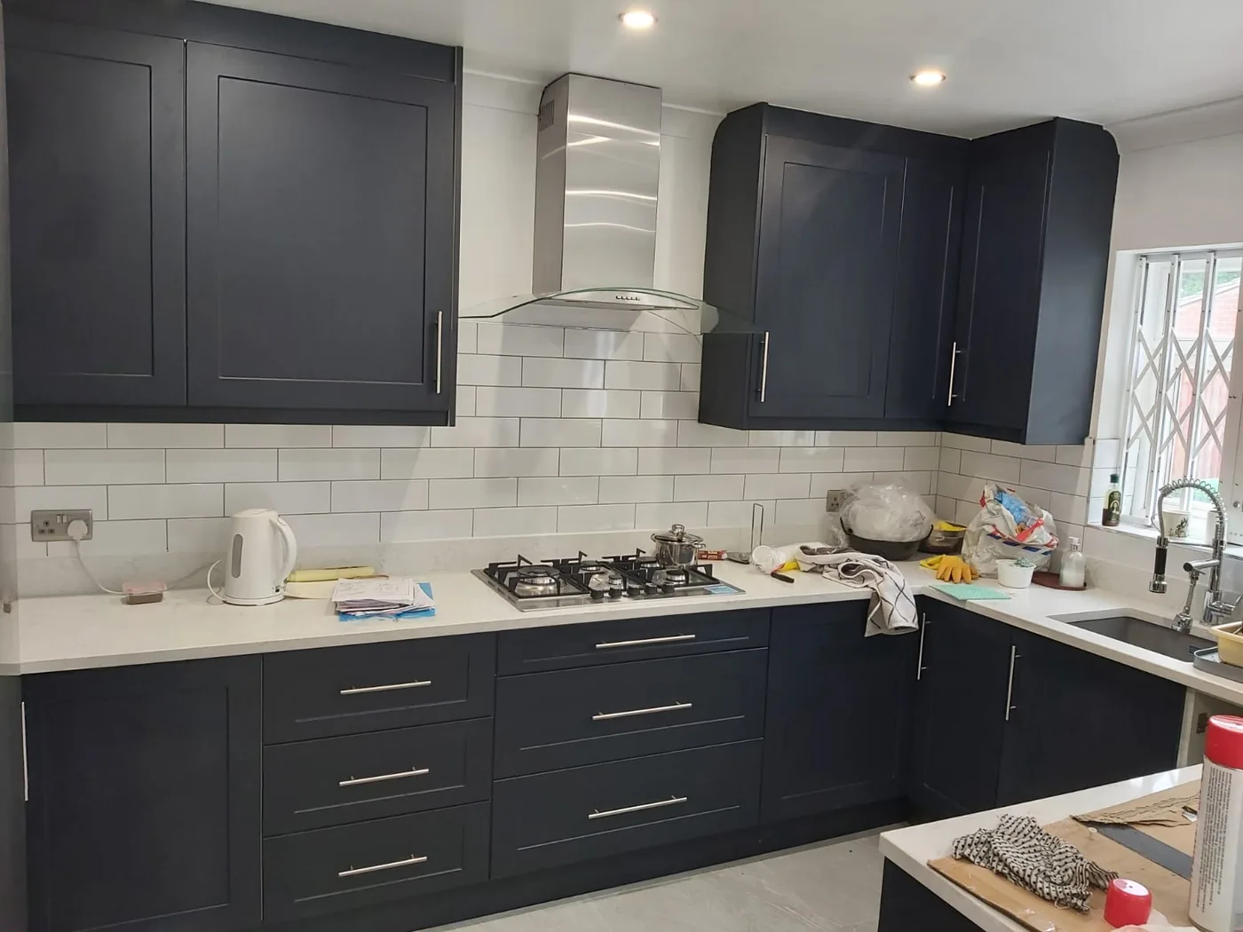 Navy shaker kitchen · white subway splashback