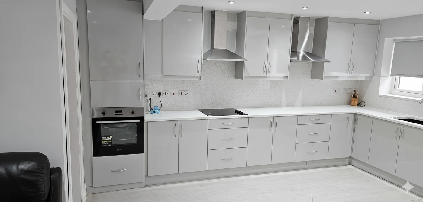 White gloss L-shape kitchen · oak butcher block top