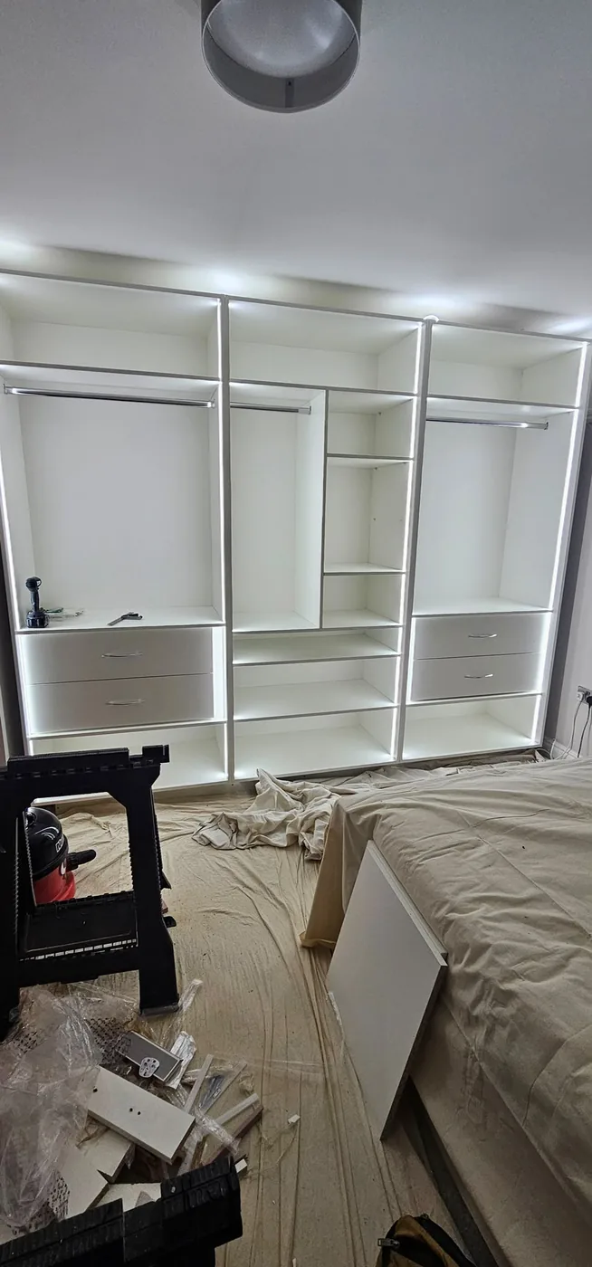 White wardrobe interior · LED edge lighting · rail, shelves & drawers
