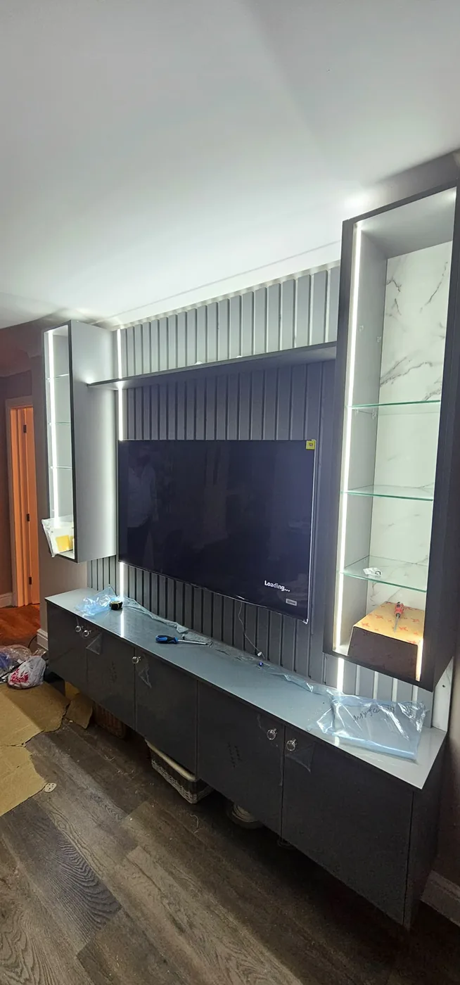 LED-lit glass display towers · marble-effect media wall