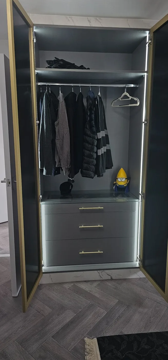 Grey wardrobe interior · LED edge lighting · gold trim