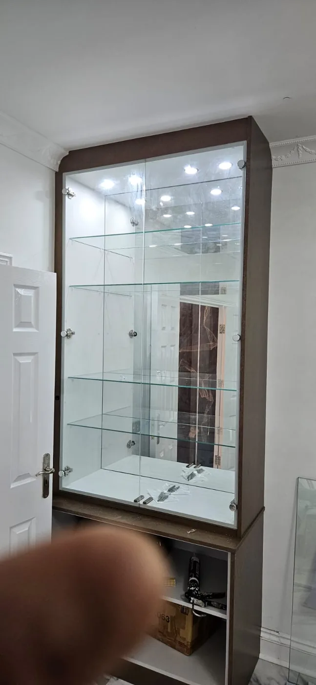 Glass display cabinet · mirrored back · glass shelving