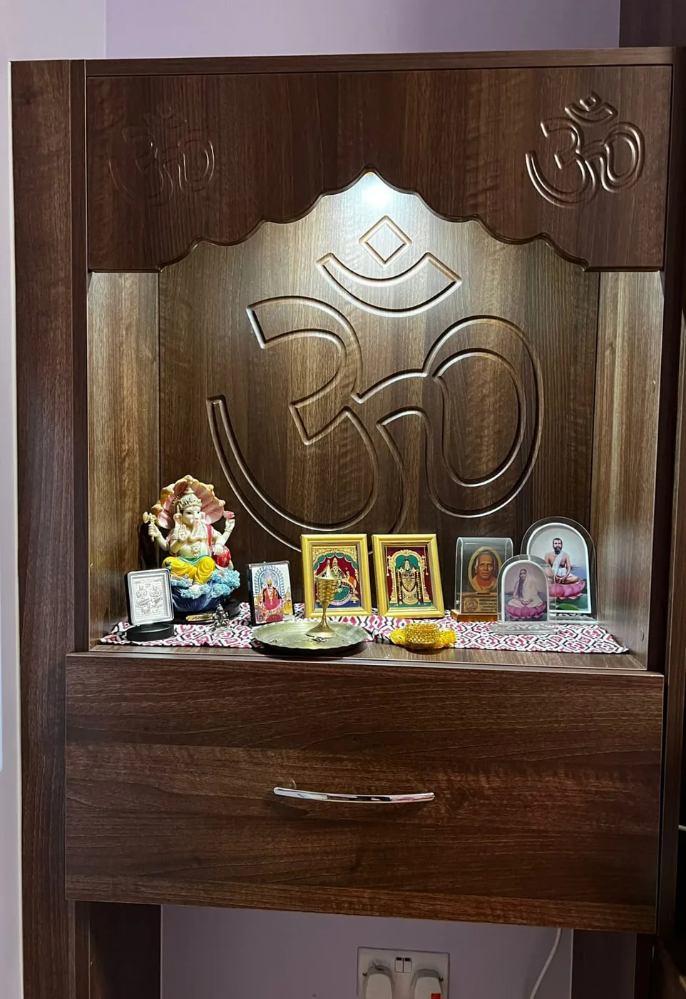 Walnut mandir unit · engraved backlit Om · drawer base