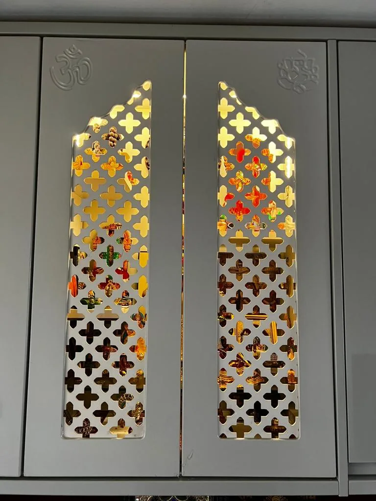 Laser-cut gold jaali cabinet doors · Om & lotus engraving