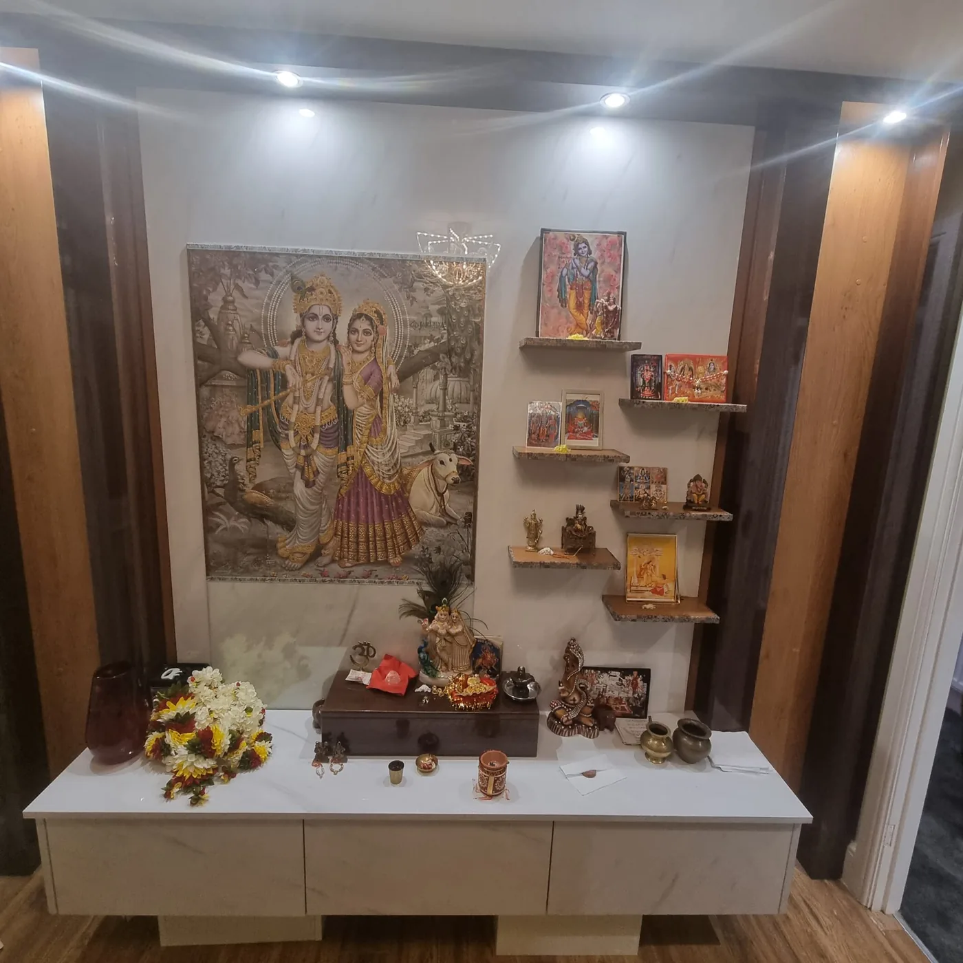 Open mandir wall shrine · Radha Krishna artwork · floating shelves