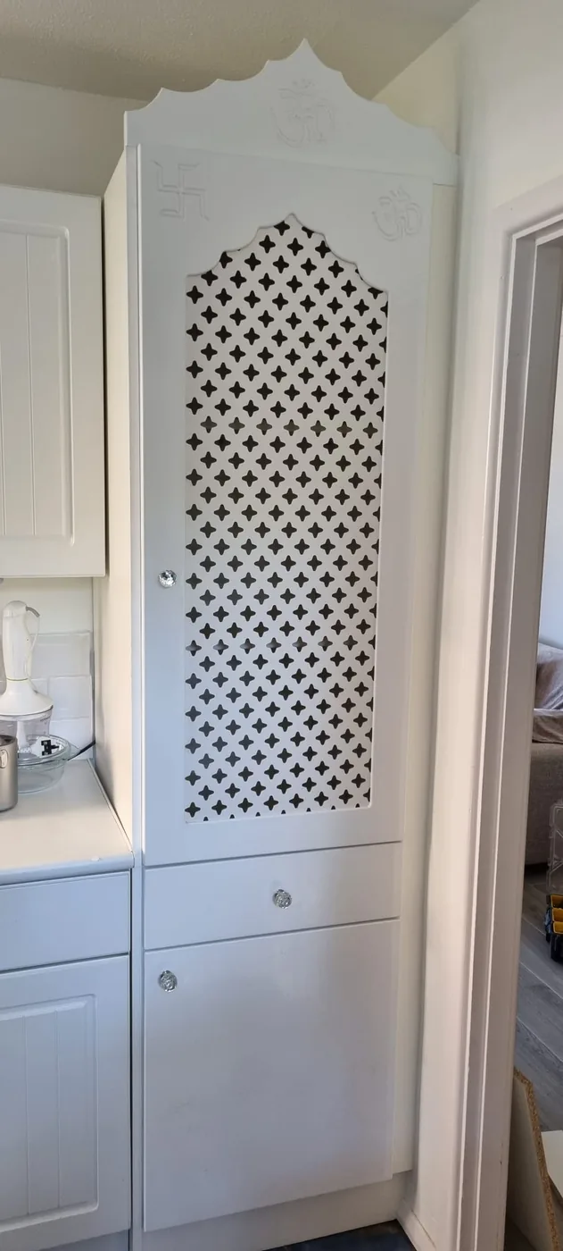 Fitted cabinet · laser-cut jaali door · Om & swastik carving