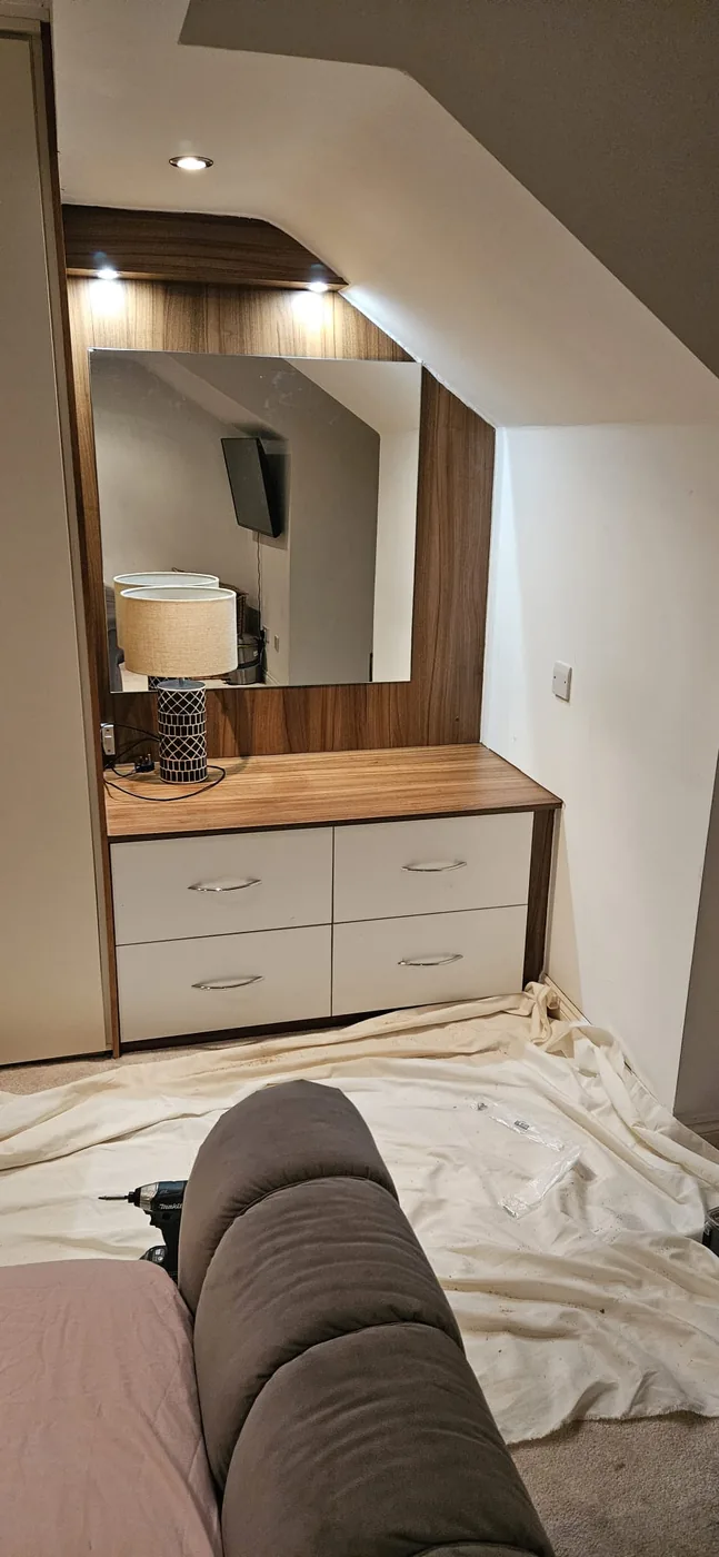 Walnut dressing table · mirror & lamp · sloped ceiling nook