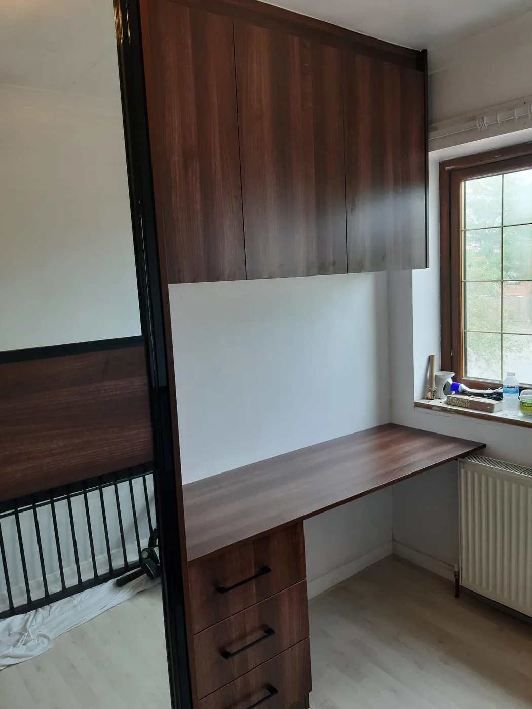 Walnut overbed desk unit · fold-down worktop · black handles