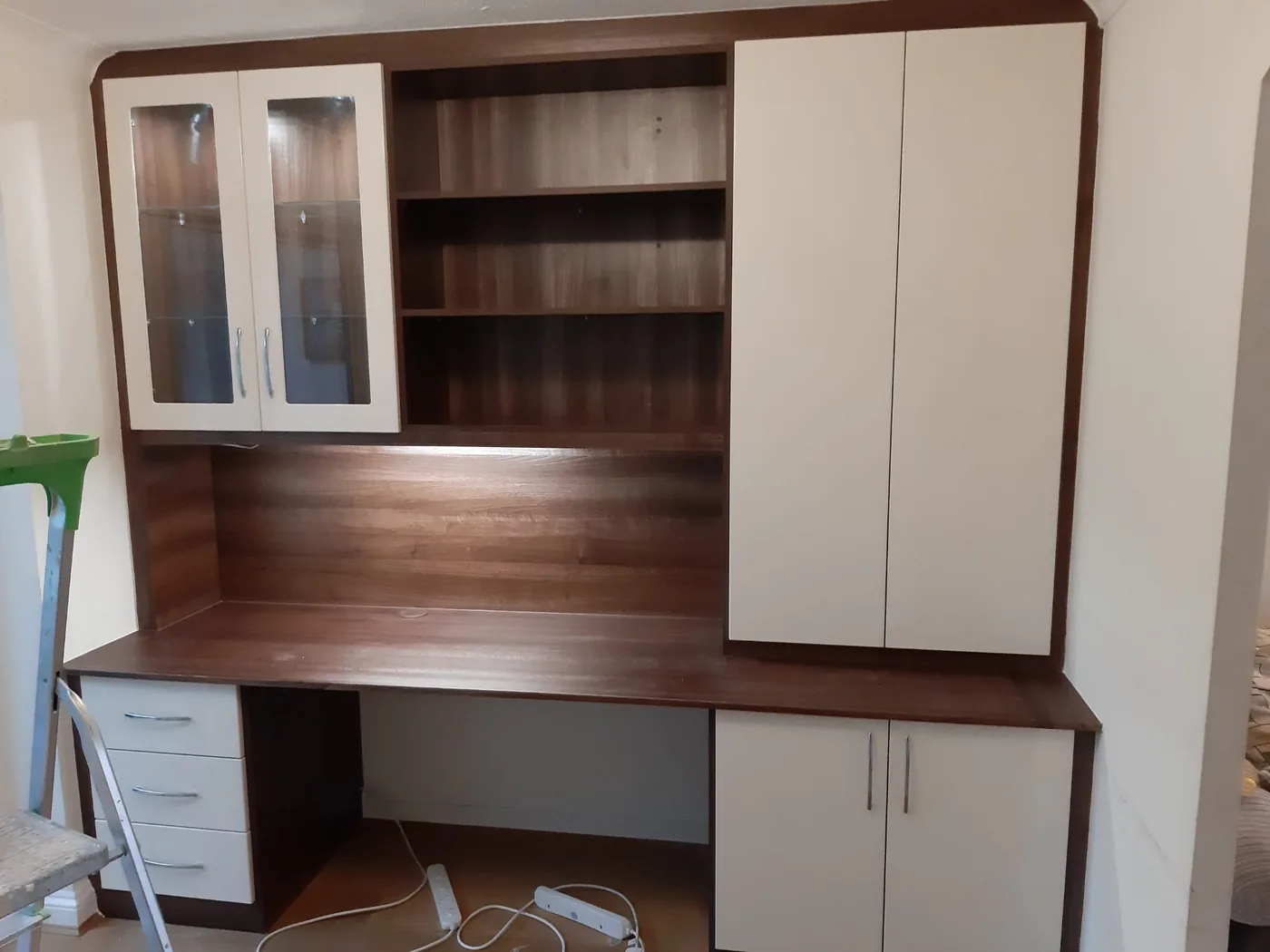 Walnut desk & bookcase wall · glass-front cabinet · open shelving