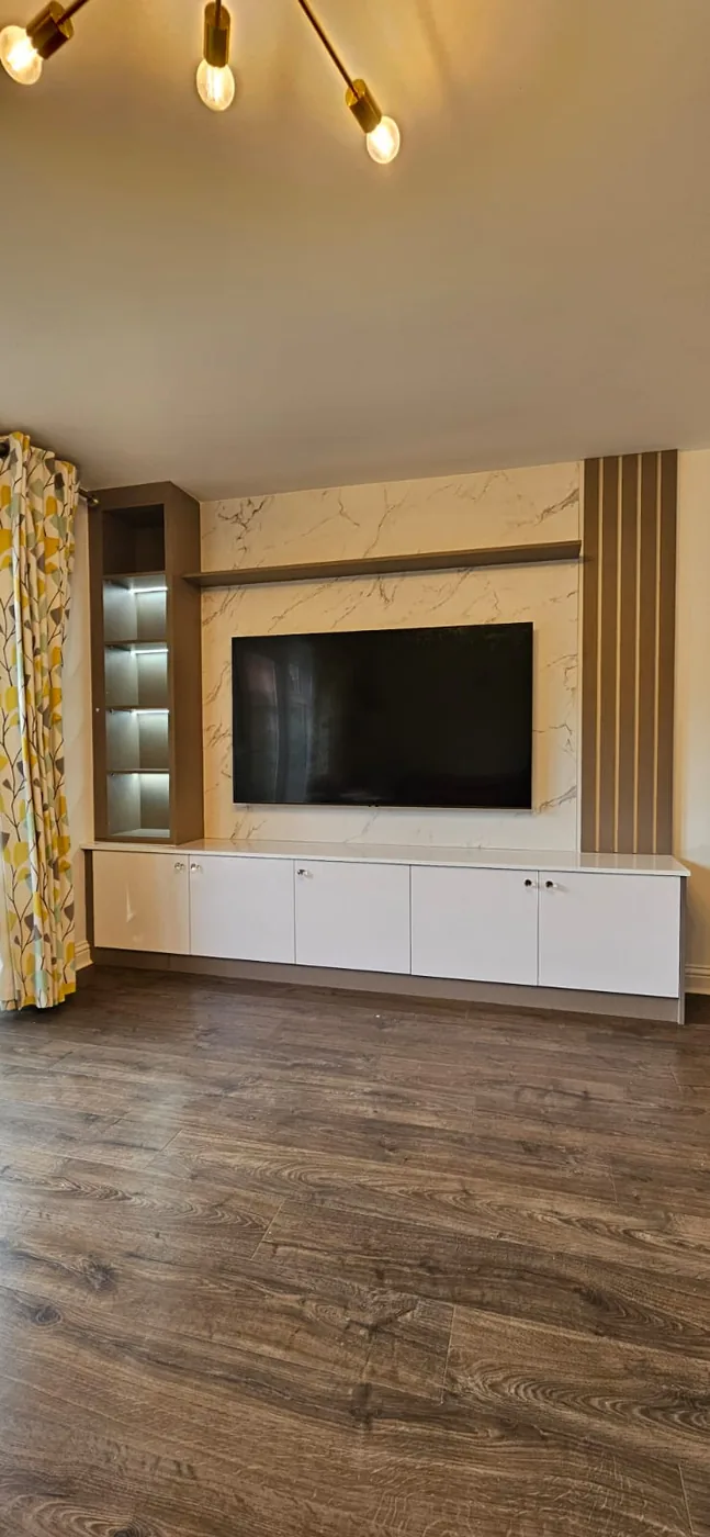 Cream marble-effect media wall · walnut open shelving