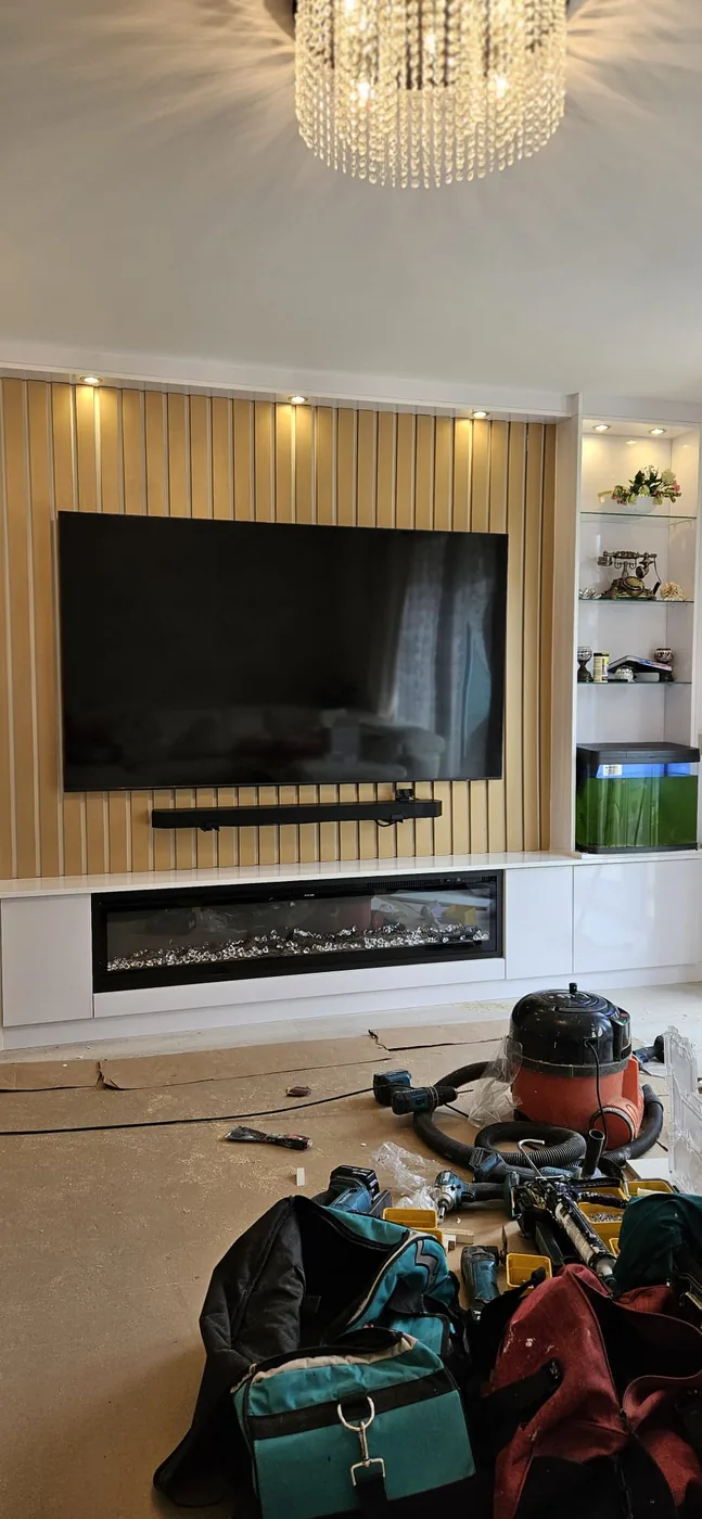 Oak slat media wall · glass display tower · built-in fire