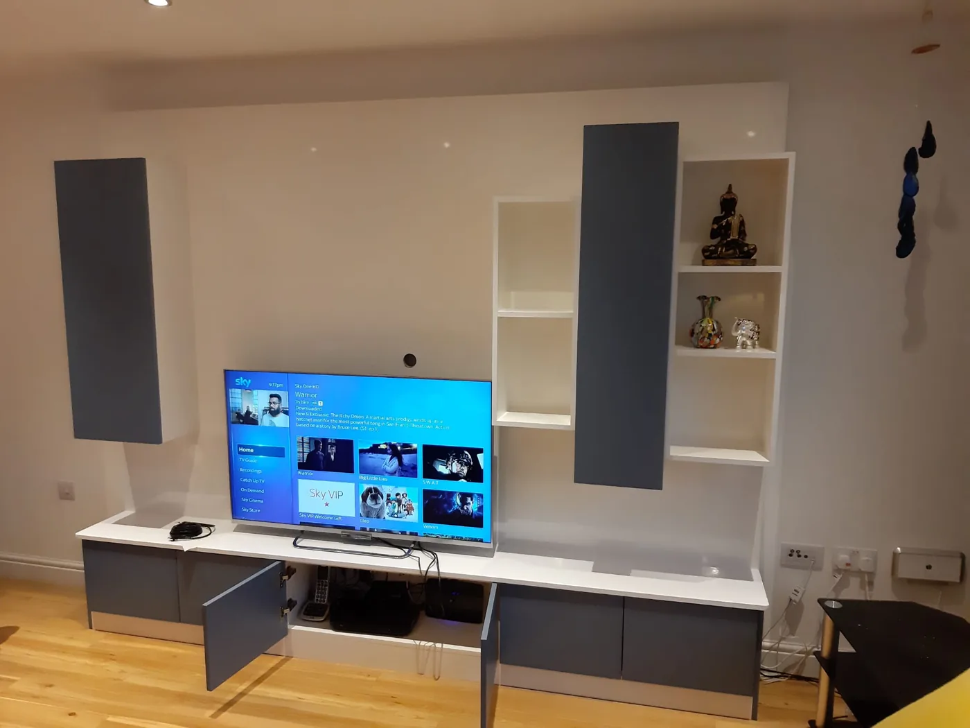 Full-wall media unit · glass display cubbies either side