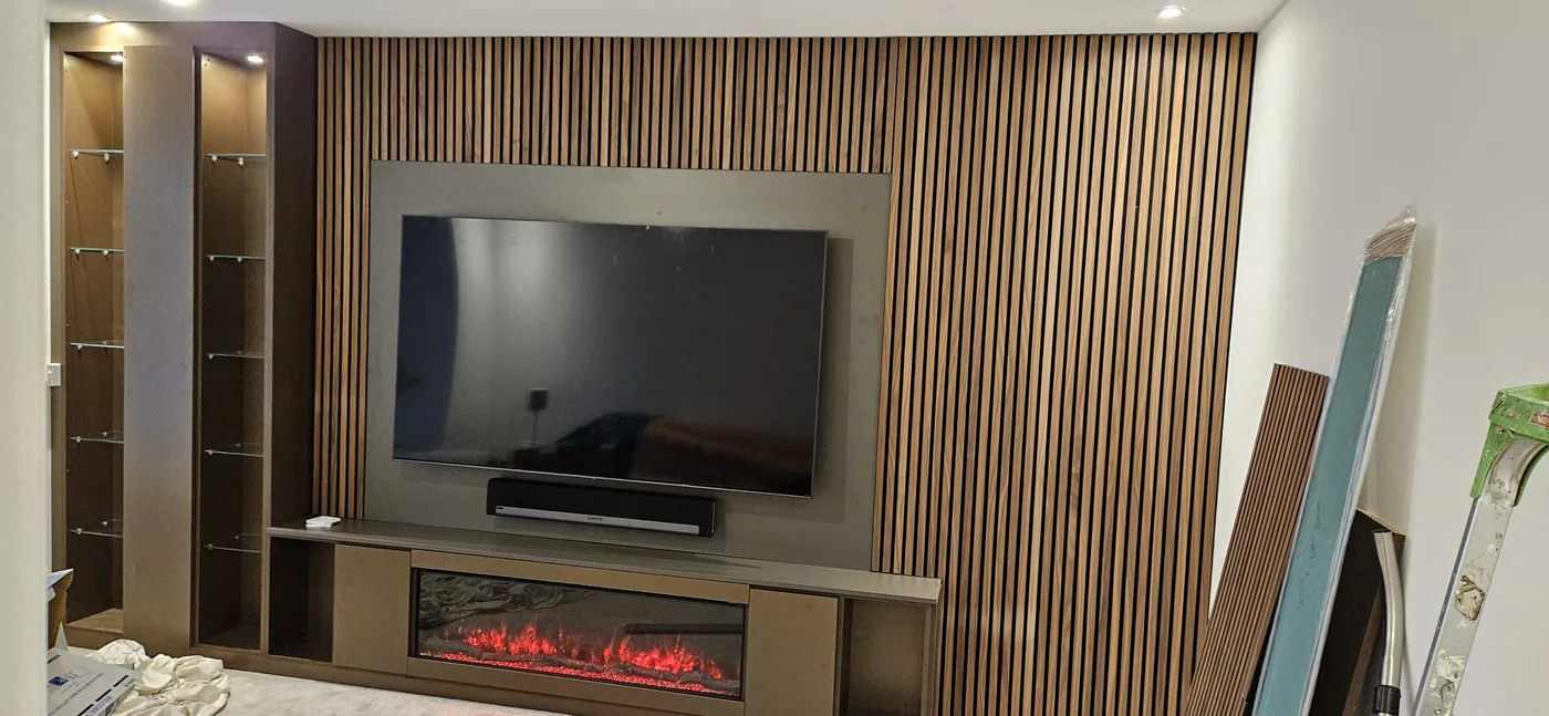 Walnut slat media wall · glass display tower · built-in fire