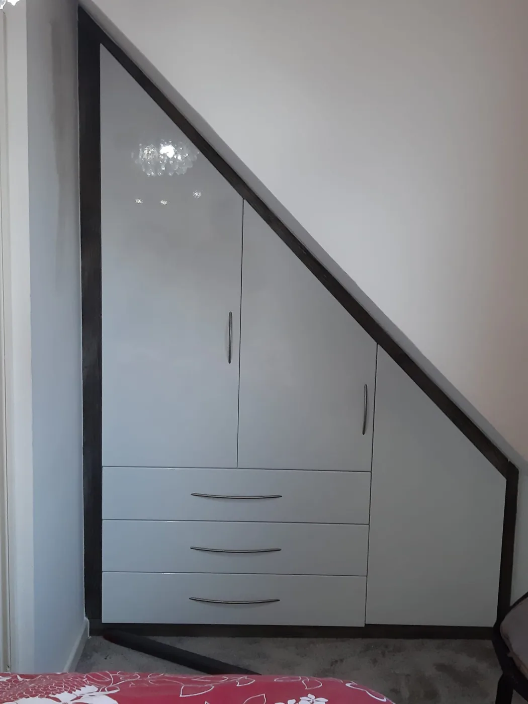 Triangular under-stair wardrobe · drawers & hanging space