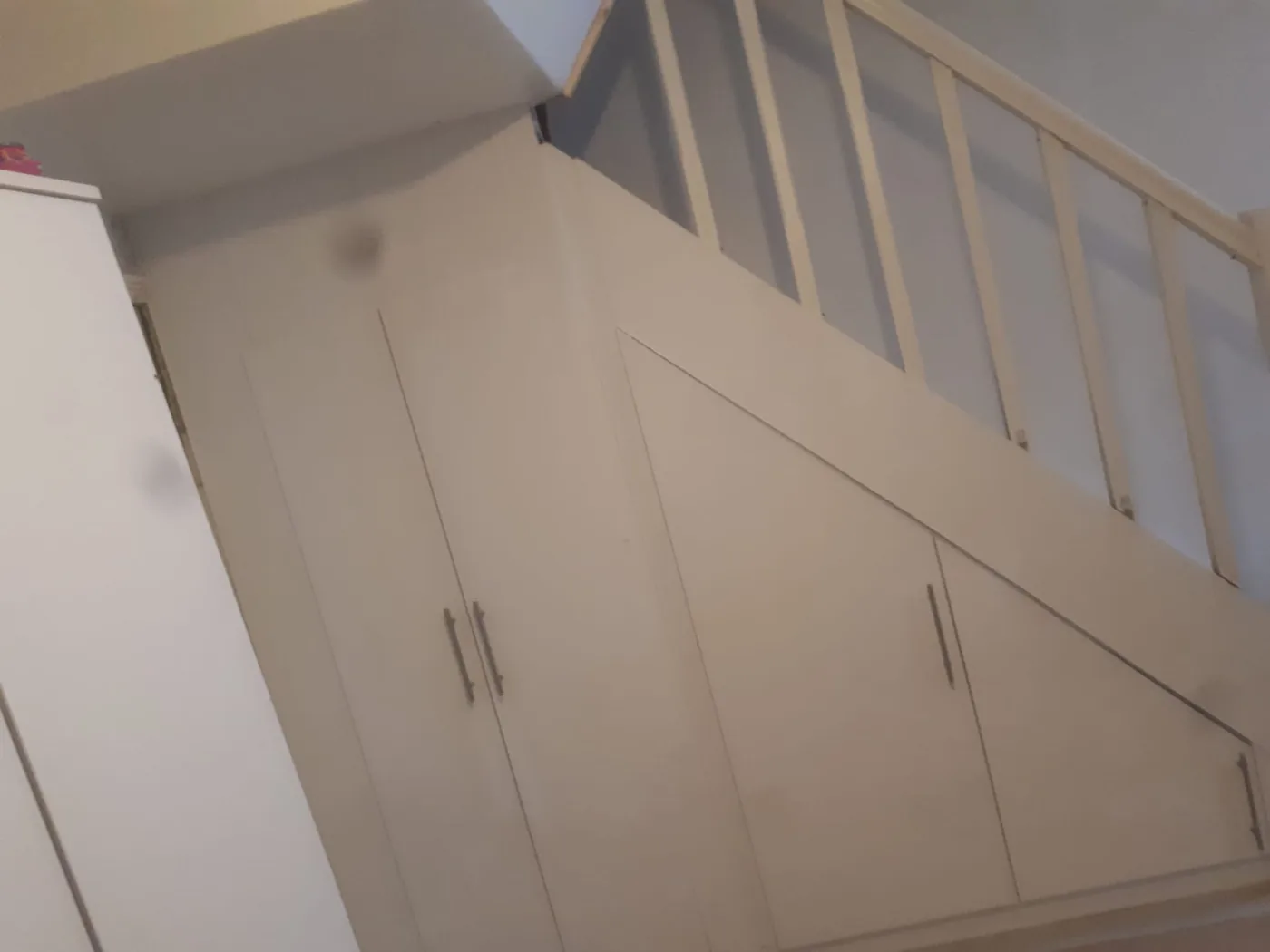 Cream under-stair storage cupboard