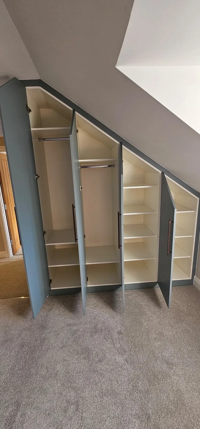 Grey-blue triangular loft wardrobe · open shelving interior