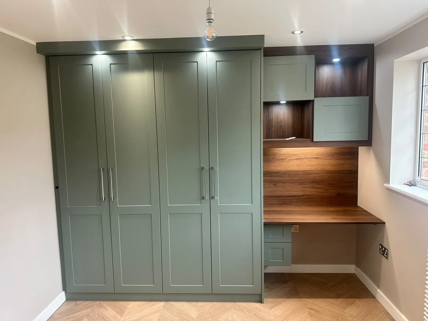 Sage green fitted wardrobe · walnut desk nook · brass handles