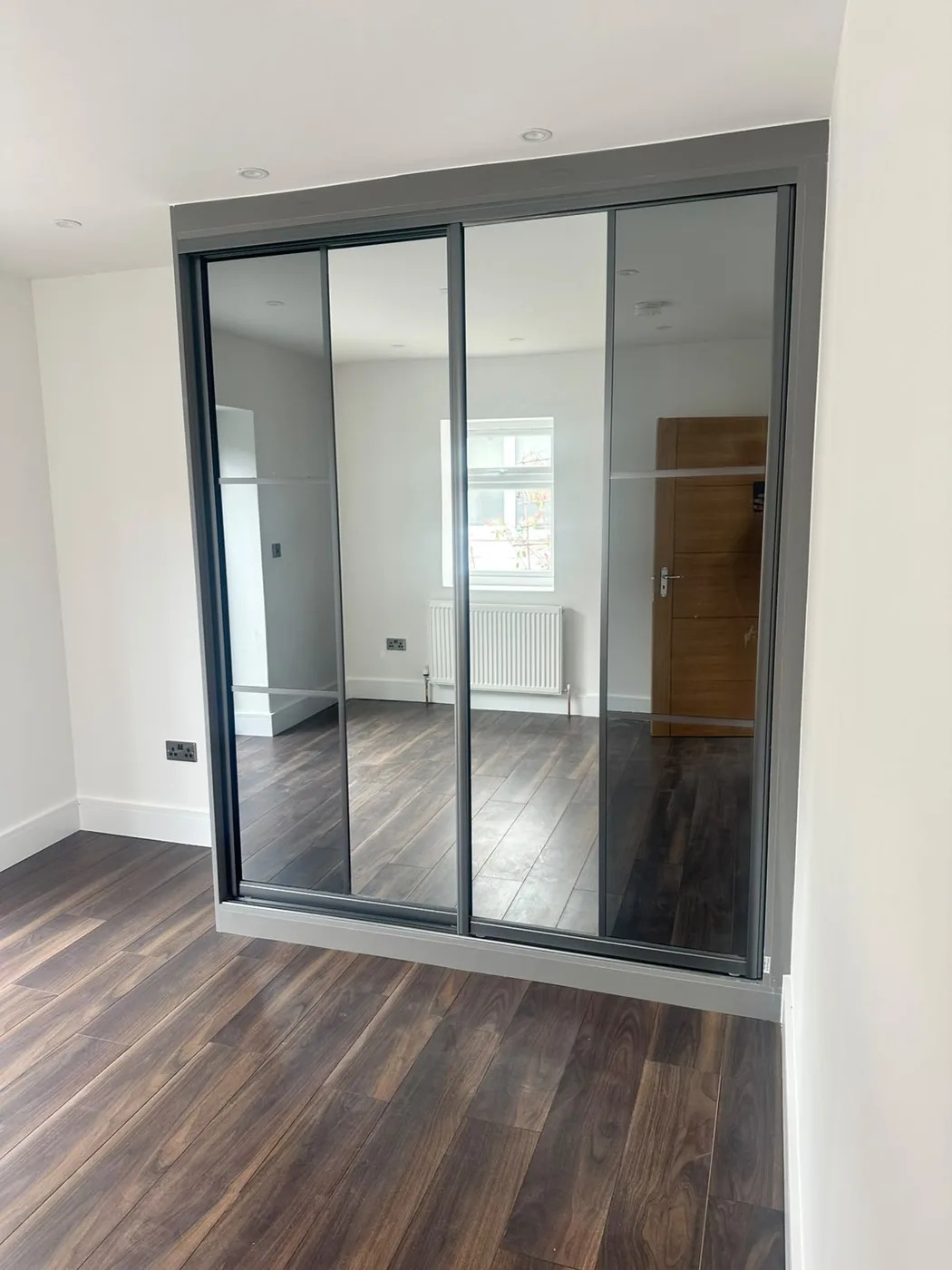 Mirrored 2-door sliding wardrobe · gunmetal frame