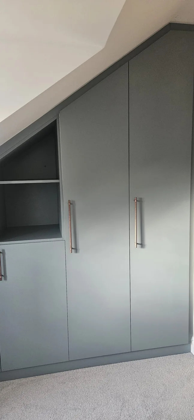 Sage-grey triangular loft wardrobe · open shelf cubby