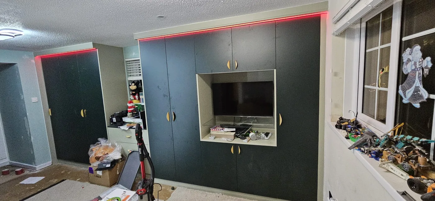 Charcoal wardrobe · built-in TV nook · LED trim