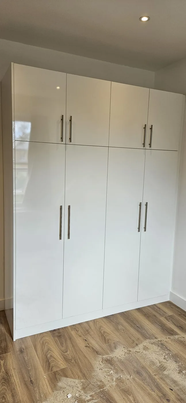 White gloss wardrobe · chrome bar handles
