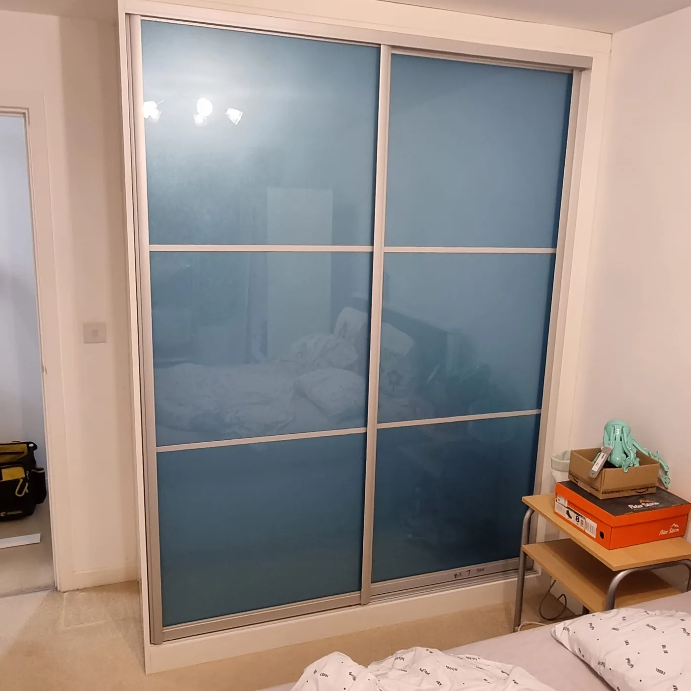 Powder blue frosted-glass sliding wardrobe