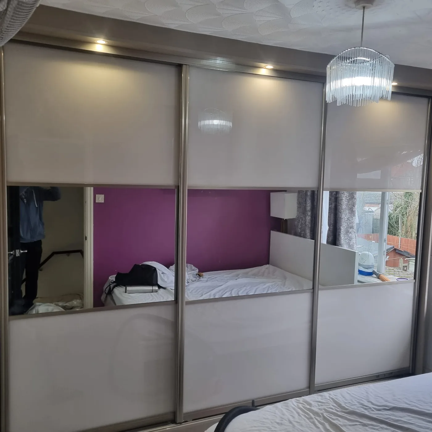 Cream sliding wardrobe · mirror centre panel · walnut frame