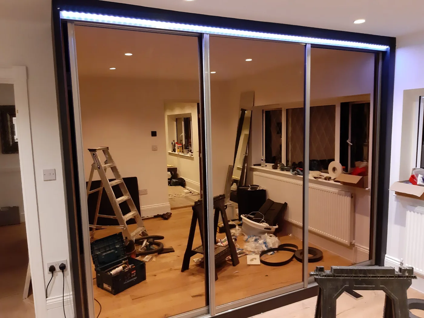 Walnut mirror & wood-panel sliding wardrobe