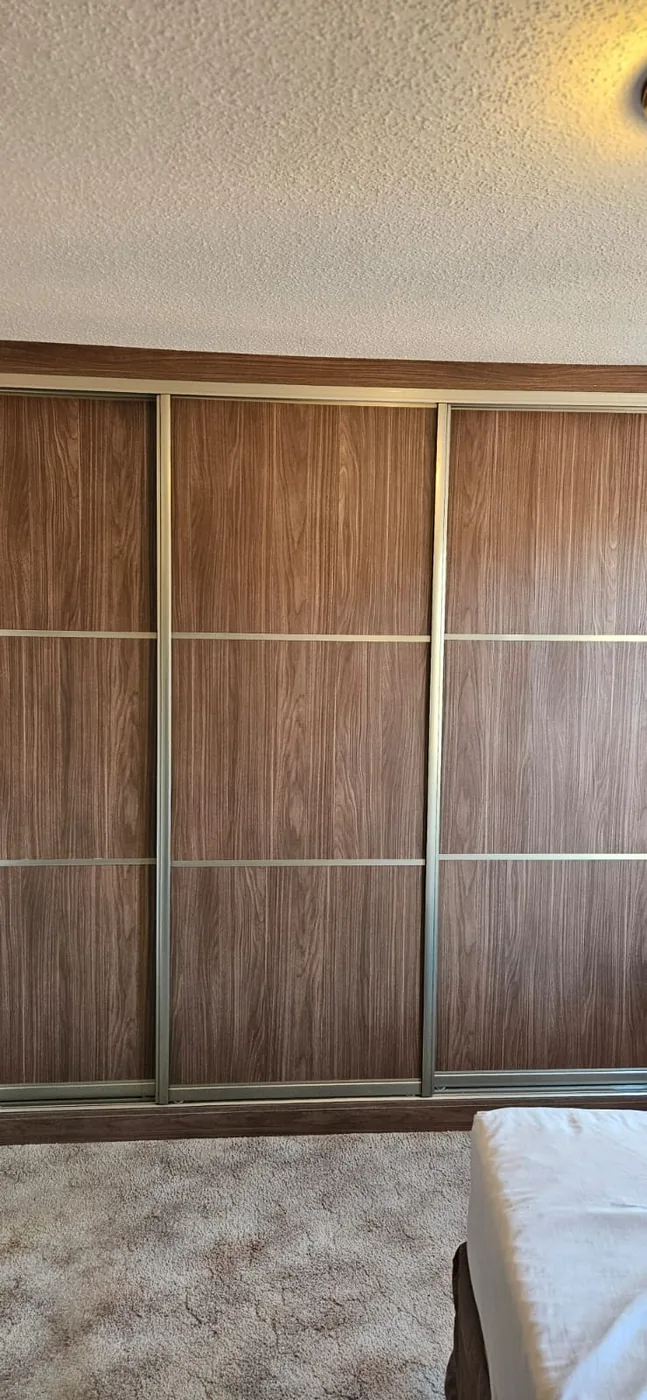 Cream frosted-glass sliding wardrobe · LED-lit interior