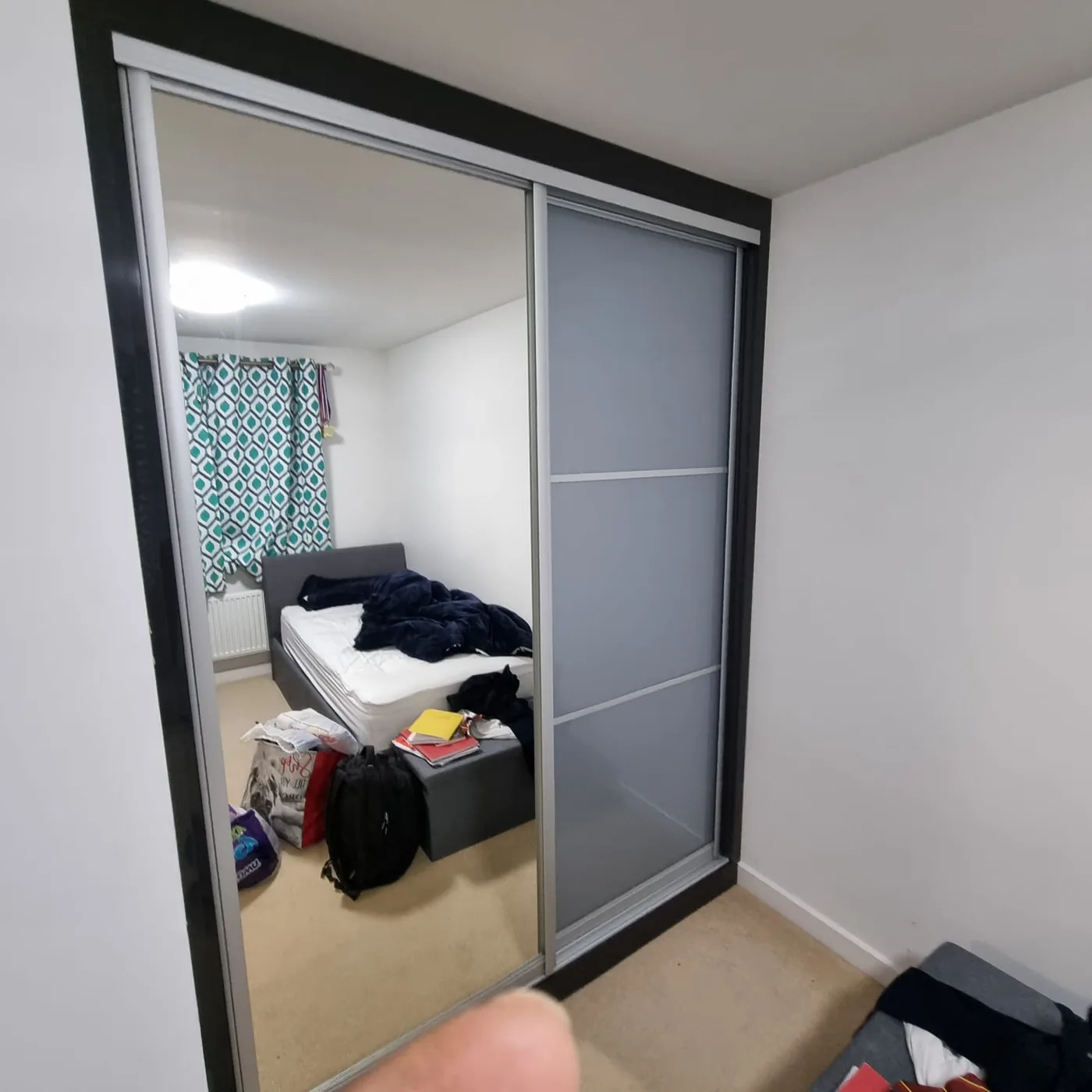 Mirror & frosted-grey sliding wardrobe · black frame