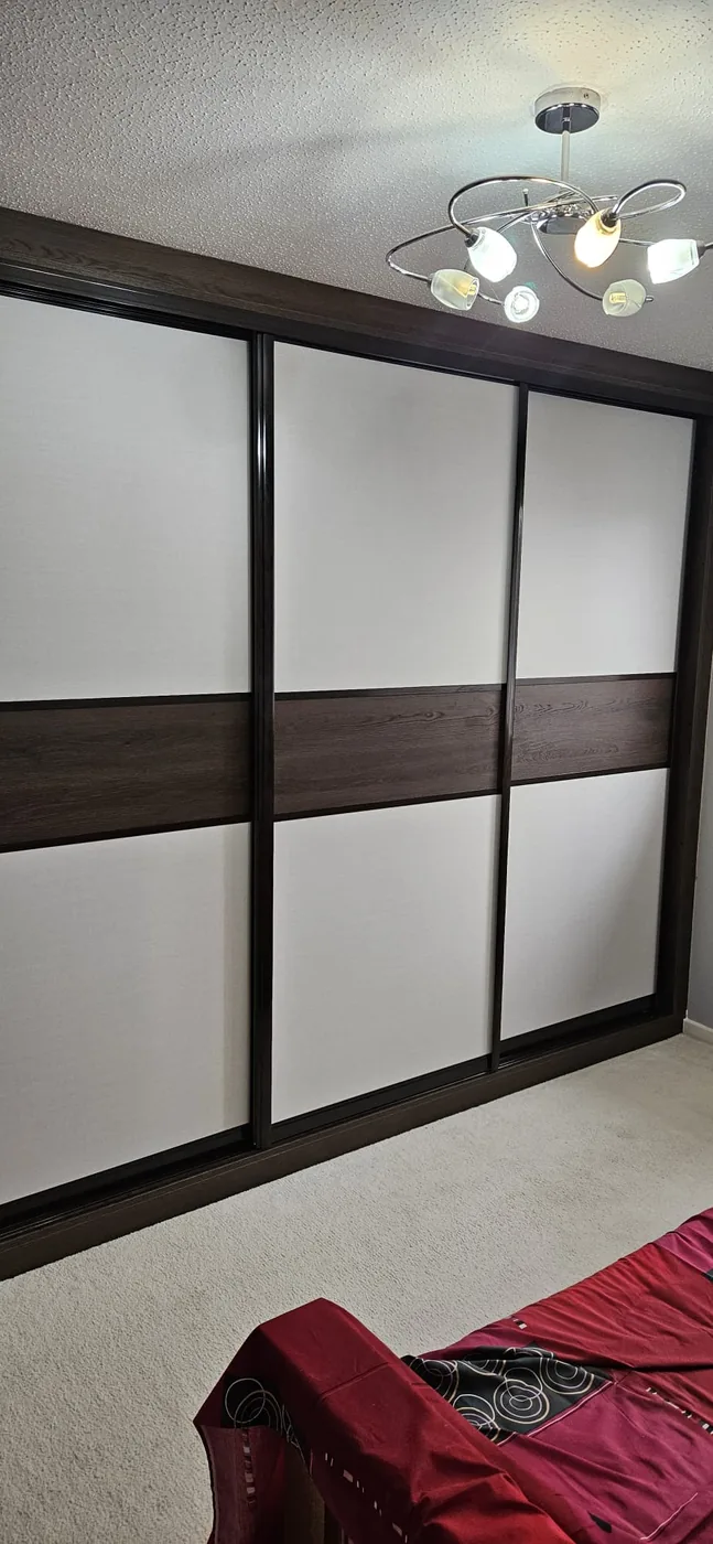 Black-framed walnut & white sliding wardrobe
