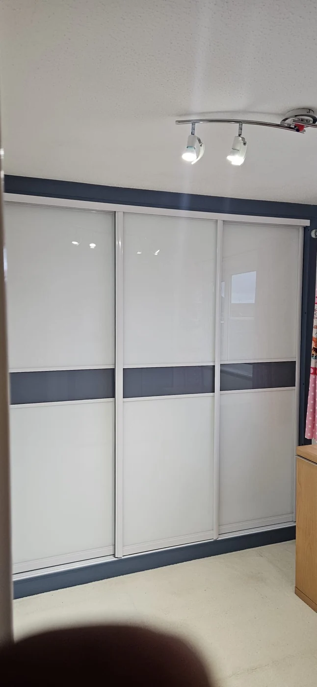 Dark-framed large mirrored sliding wardrobe doors